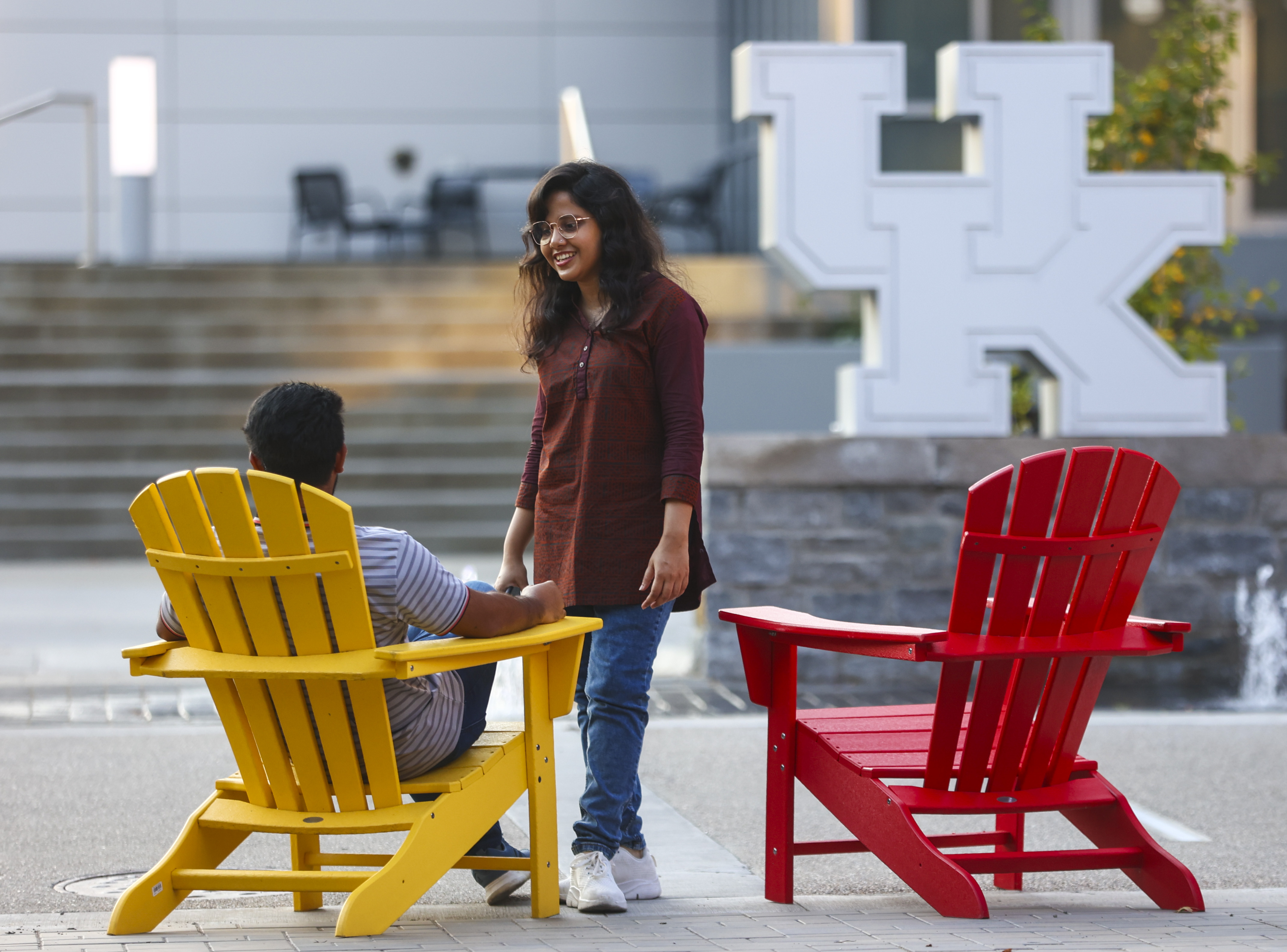 students talking on campus in front of alumni