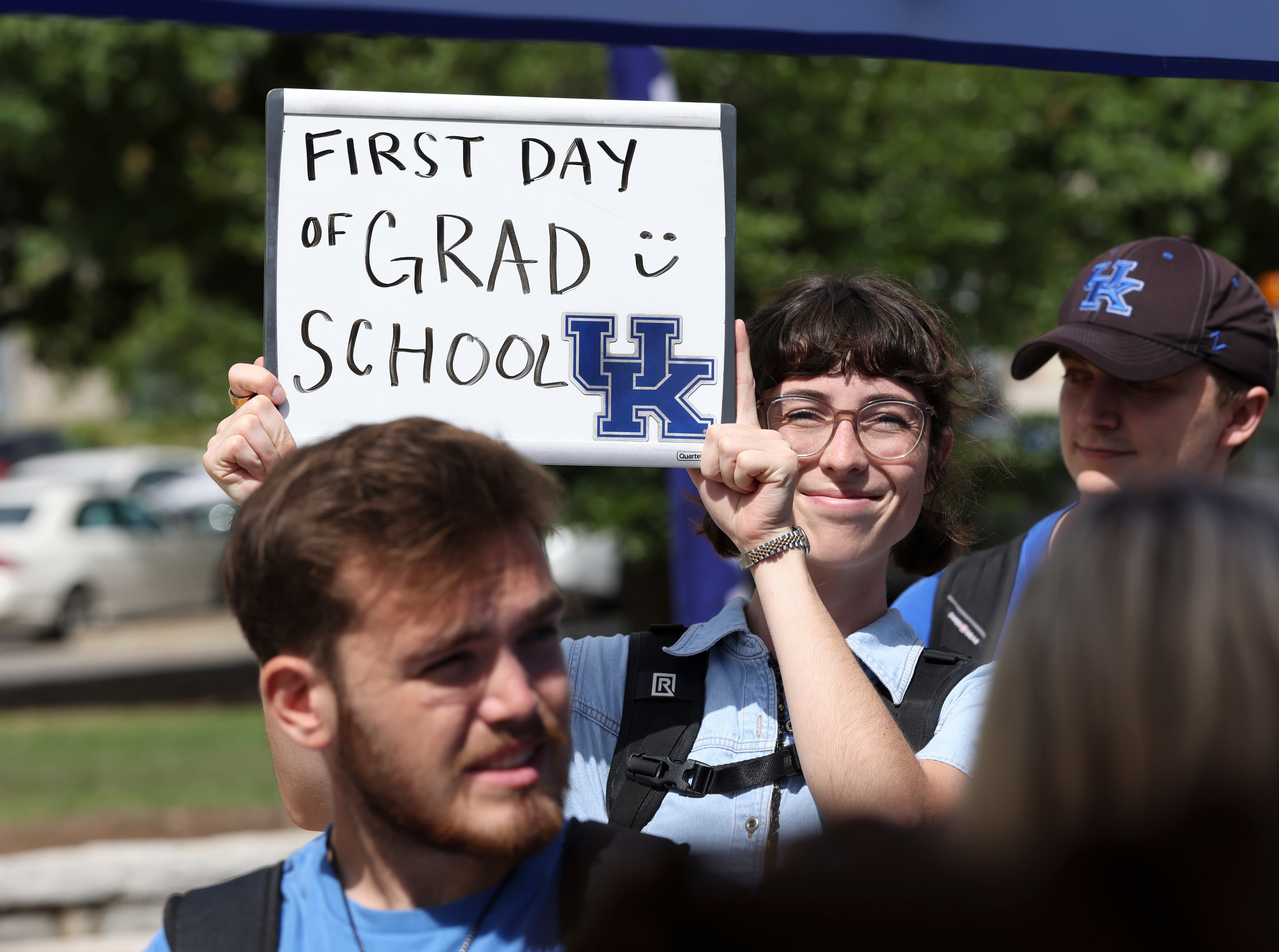 first day of grad school student holding sign with UK logo 