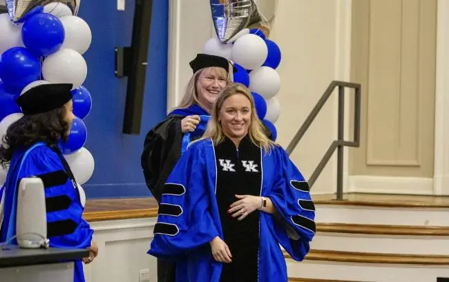 graduate student hooding ceremony graduation with baloons