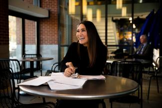 woman with paperwork smiling