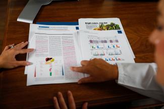 person pointing to information on a page to someone