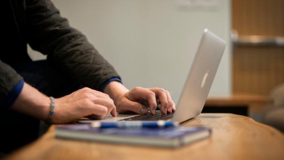 hands working on laptop