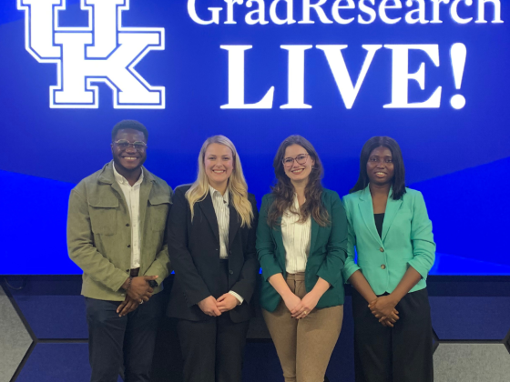 Graduate students present three minute talks at The Cornerstone during GradResearch Live 2025 with a full audience. Pre Three Minute Thesis winners Tiffany Odita, Hammas Khalid, and Maddie Kushner, and Three Minute Thesis winners Alyson Ackerman, Courtney Martin, Odianosen Ewah, and People’s Choice Damilola Petinrin on stage.