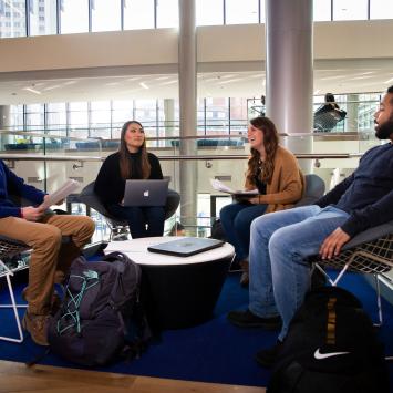 students conversing around table